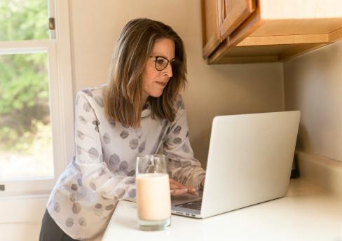 Woman with laptop contemplating employment 