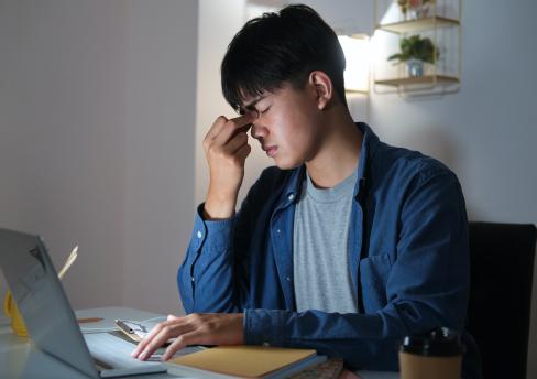 Stressed employee sitting at laptop