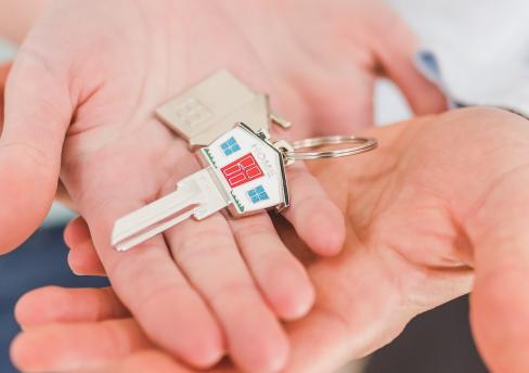 Hands holding a house key