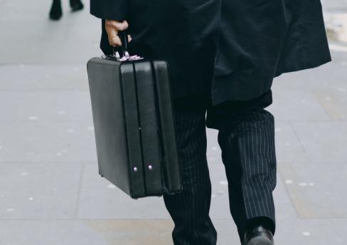 Business person, walking with briefcase. 