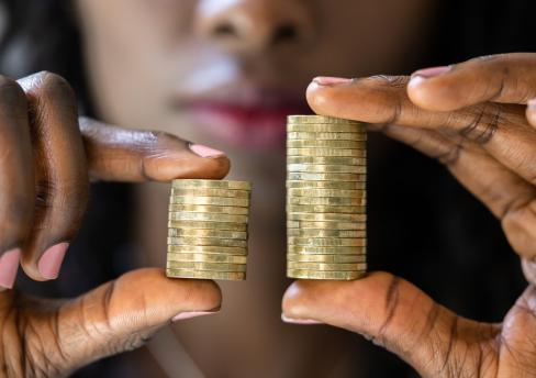 Women holding money, pay discrepancy 